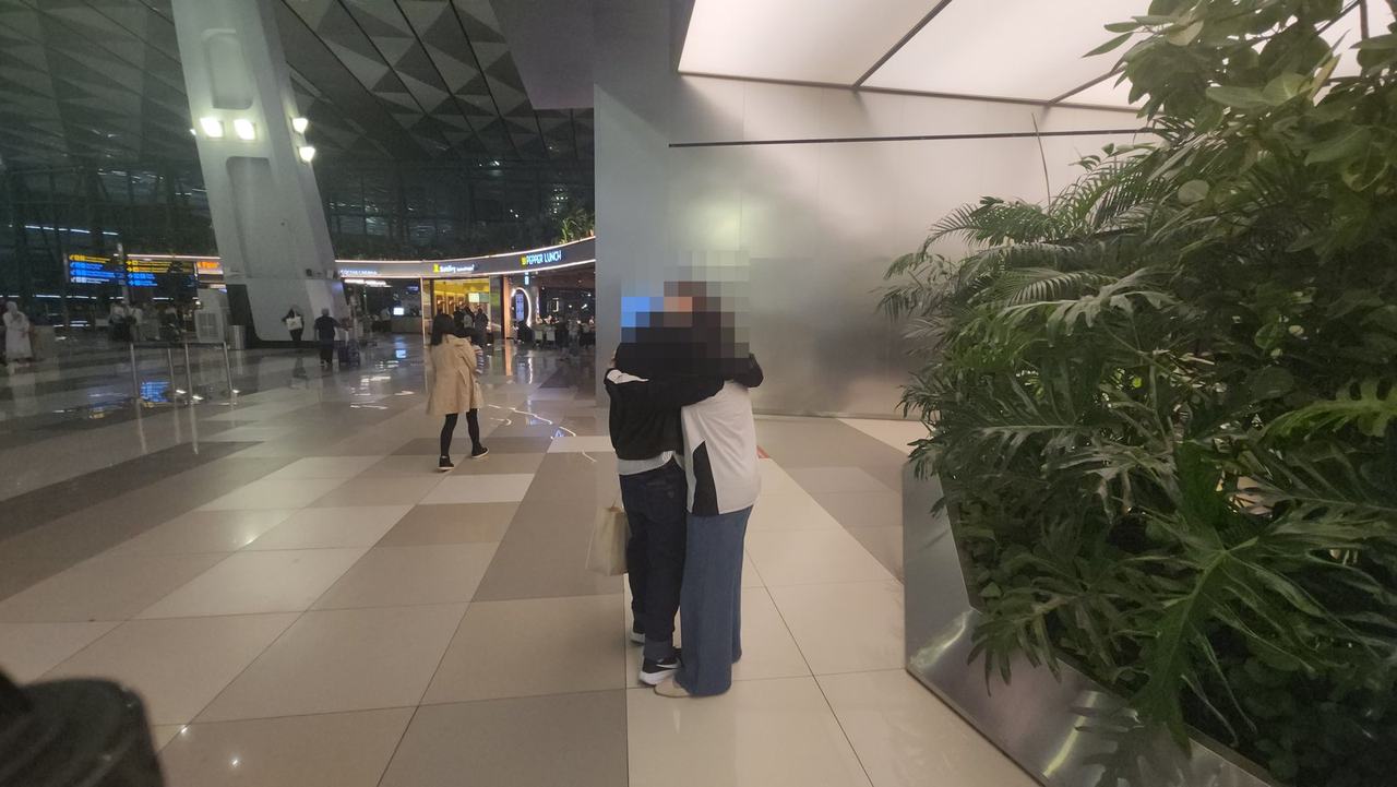 공항에서 포옹하는 커플